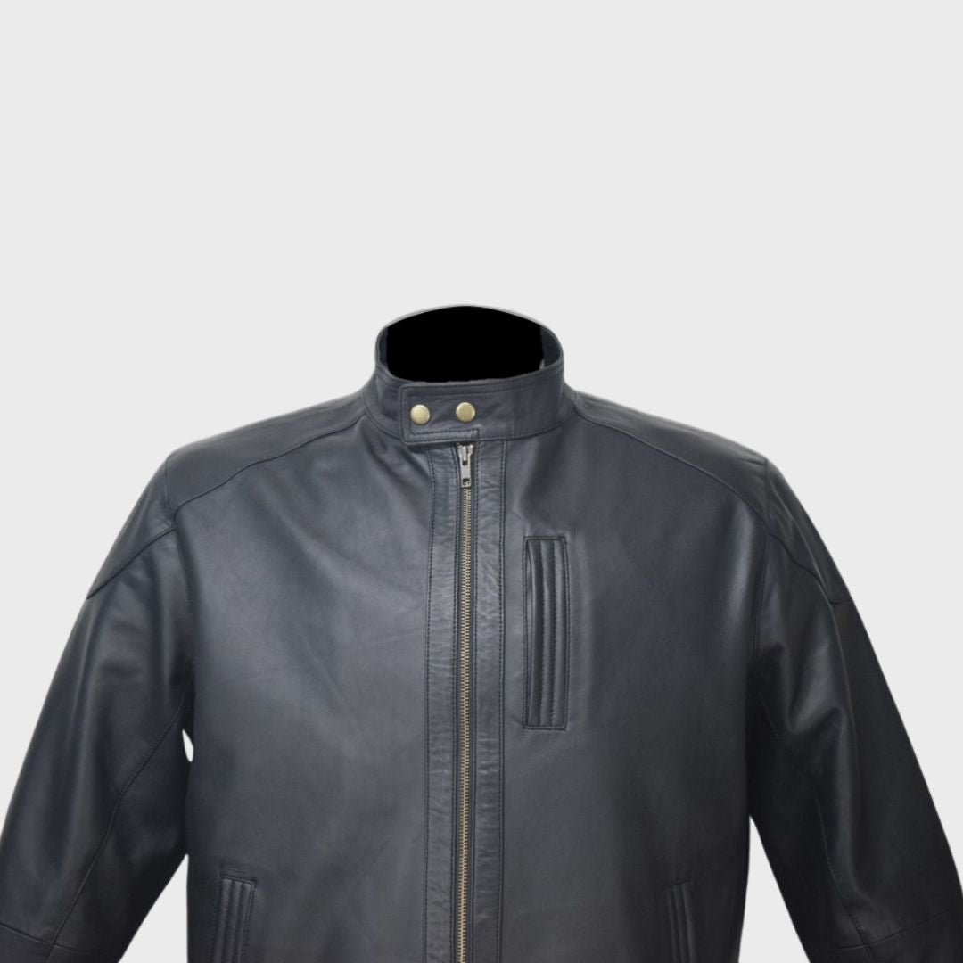 Close-up of the band collar and chest pocket on a men’s black leather biker jacket.