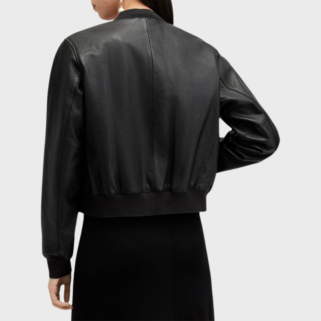 woman wearing black leather bomber jacket over a bodycon