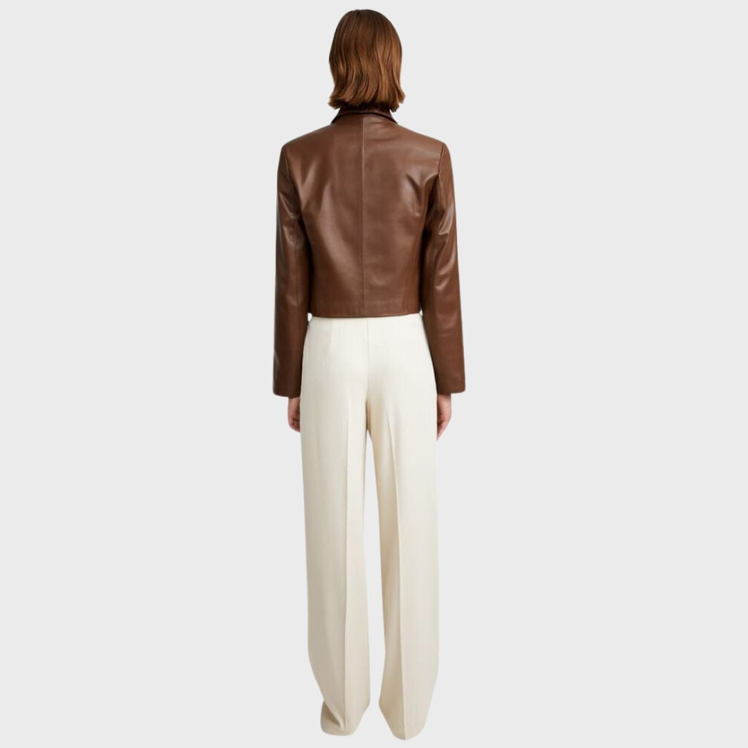 Golden hair woman wearing lambskin leather jacket with white pants