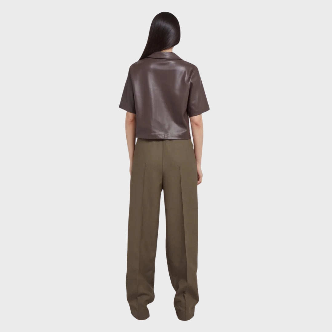 asian girl wearing chocolate brown leather shirt over brown office pants